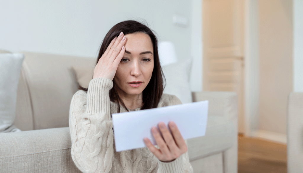 portrait-of-a-worried-asian-woman-looking-at-received-letter-at-home-beautiful-woman-with-worried-facial-expression-looking-at-received-mail-web