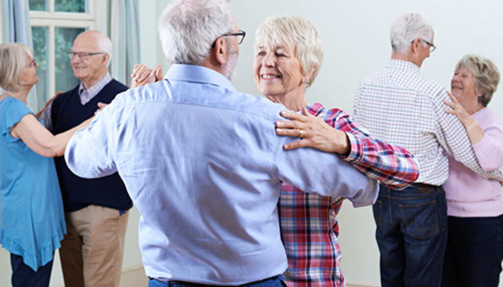 Group Of Seniors Enjoying Dancing Club Together
