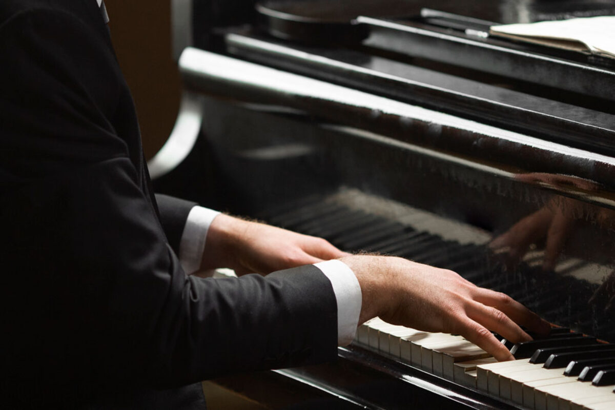 side-view-hands-playing-piano