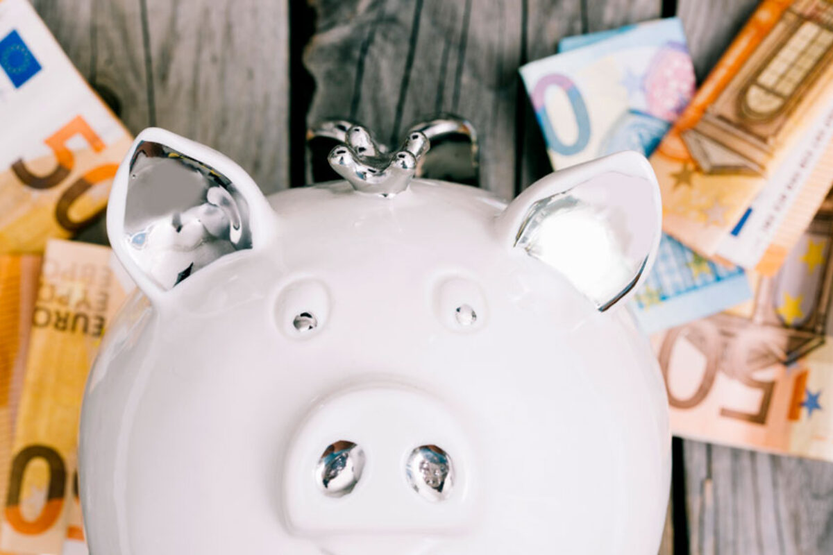 close-up-white-piggybank-s-face-with-euro-banknotes