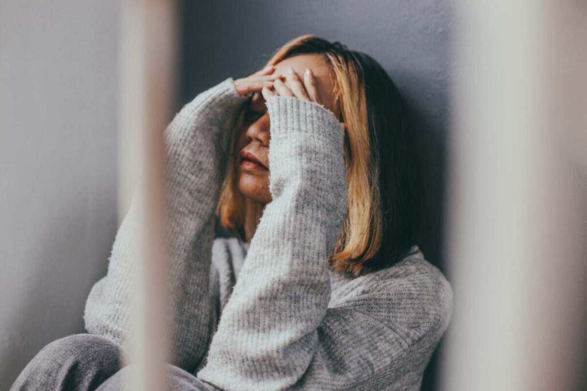 depressed-sad-young-woman-sitting-alone-home