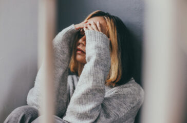 depressed-sad-young-woman-sitting-alone-home