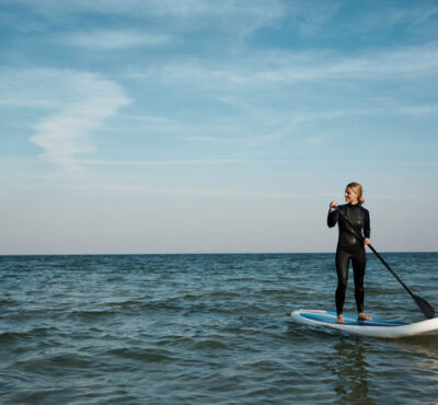 young-blonde-female-paddleboard-sea