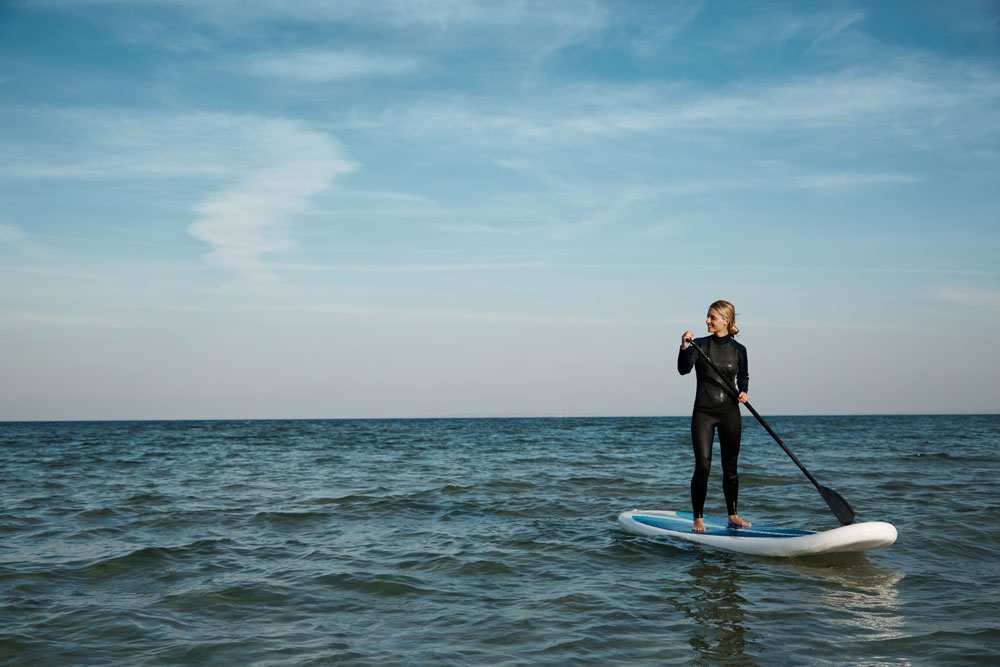 young-blonde-female-paddleboard-sea