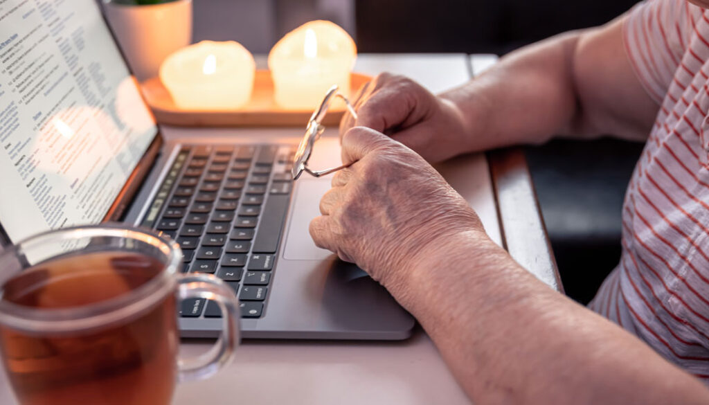 retired-woman-uses-laptop-hands-close-up-2