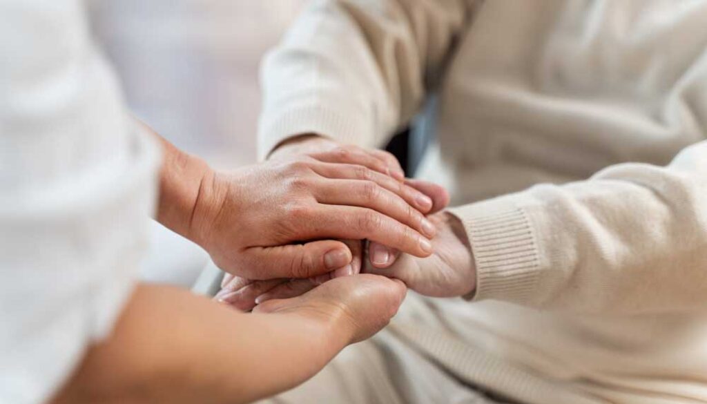 doctor-holding-hands-with-senior-patient-2